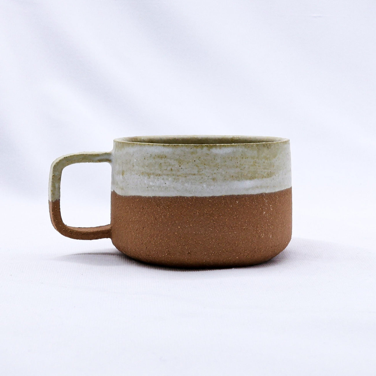 Ceramic mug with two-tone design on a white background