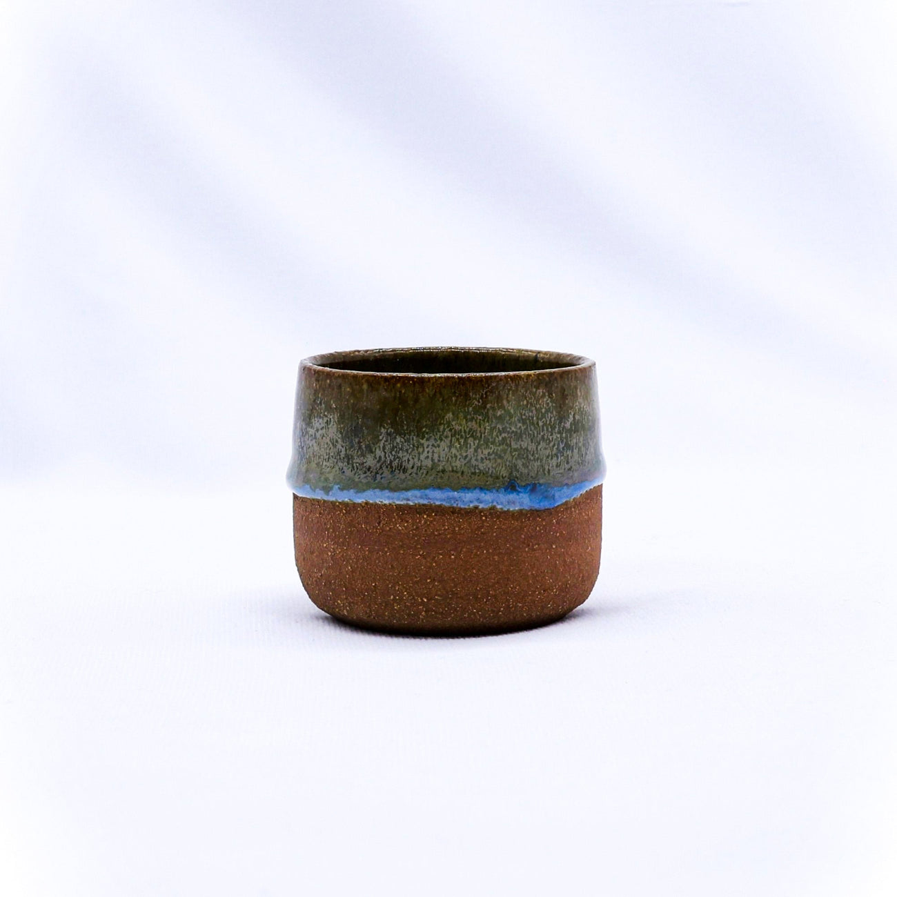 Ceramic cup with two-tone design on a white background