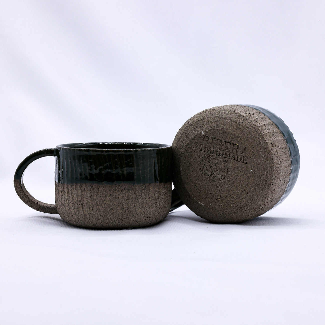 Ceramic mug and matching coaster with 'Piper Handmade' branding on a white background