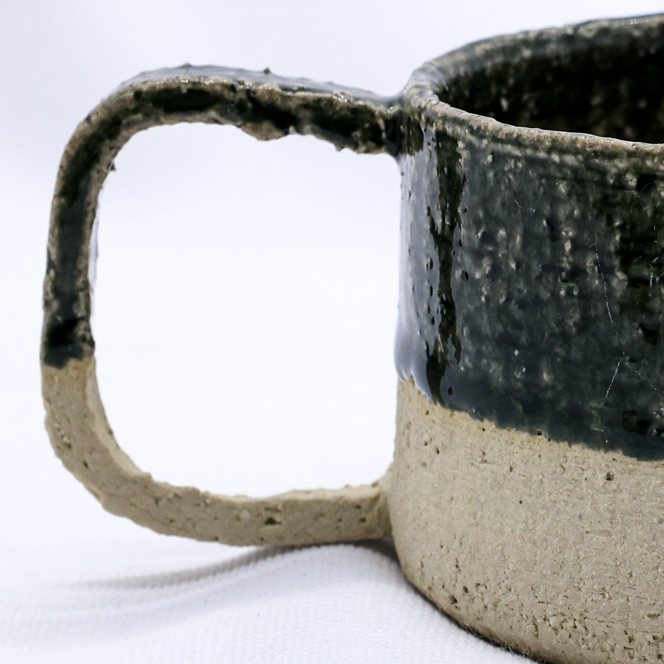 Ceramic mug with a speckled glaze on a white background