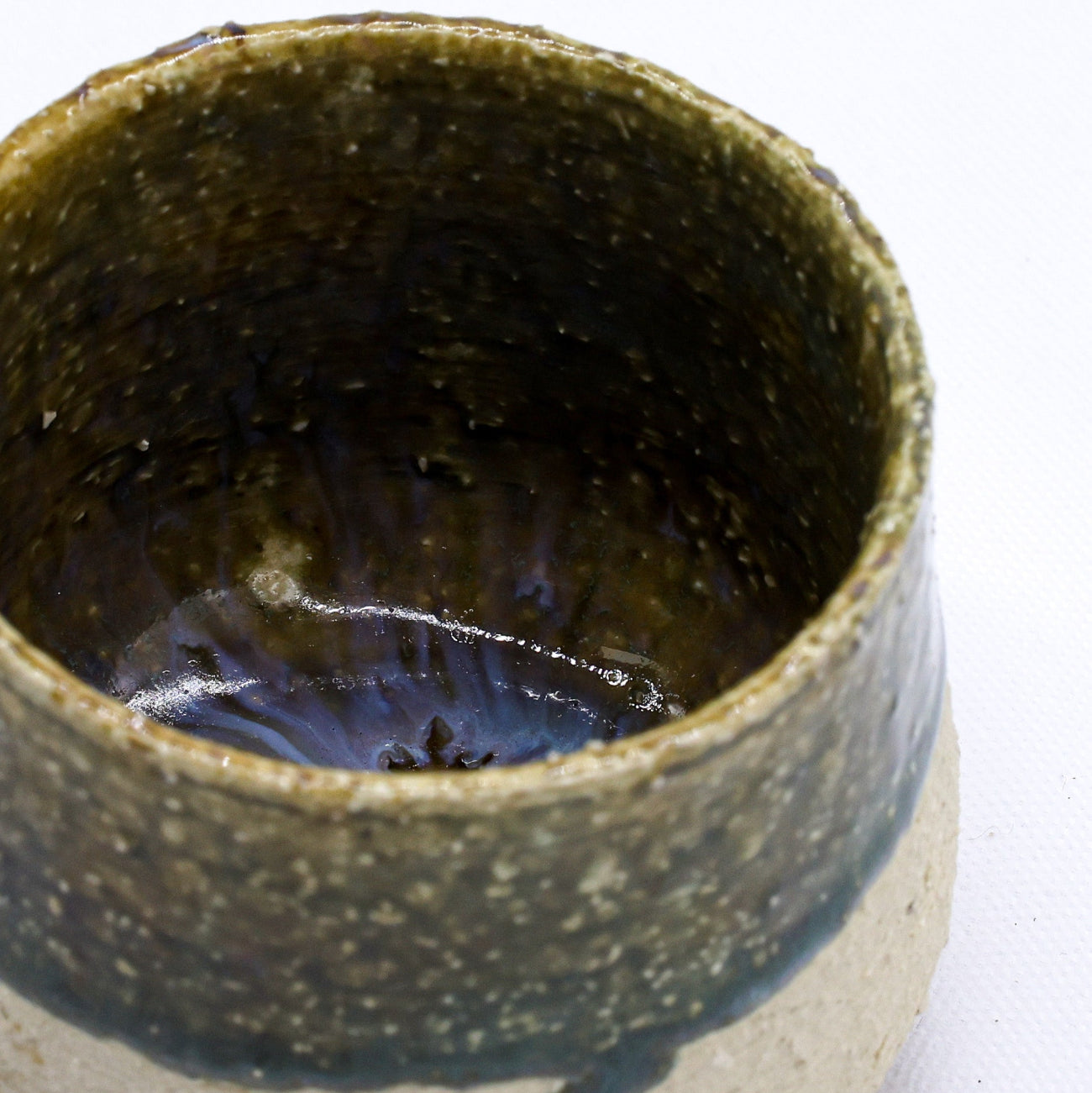 Ceramic cup with a textured surface on a white background