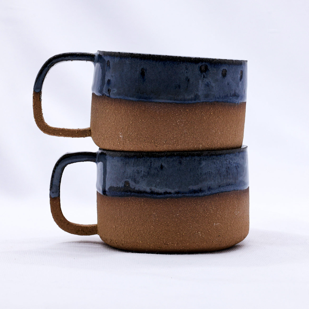 Ceramic mug with blue and brown glaze on a white background