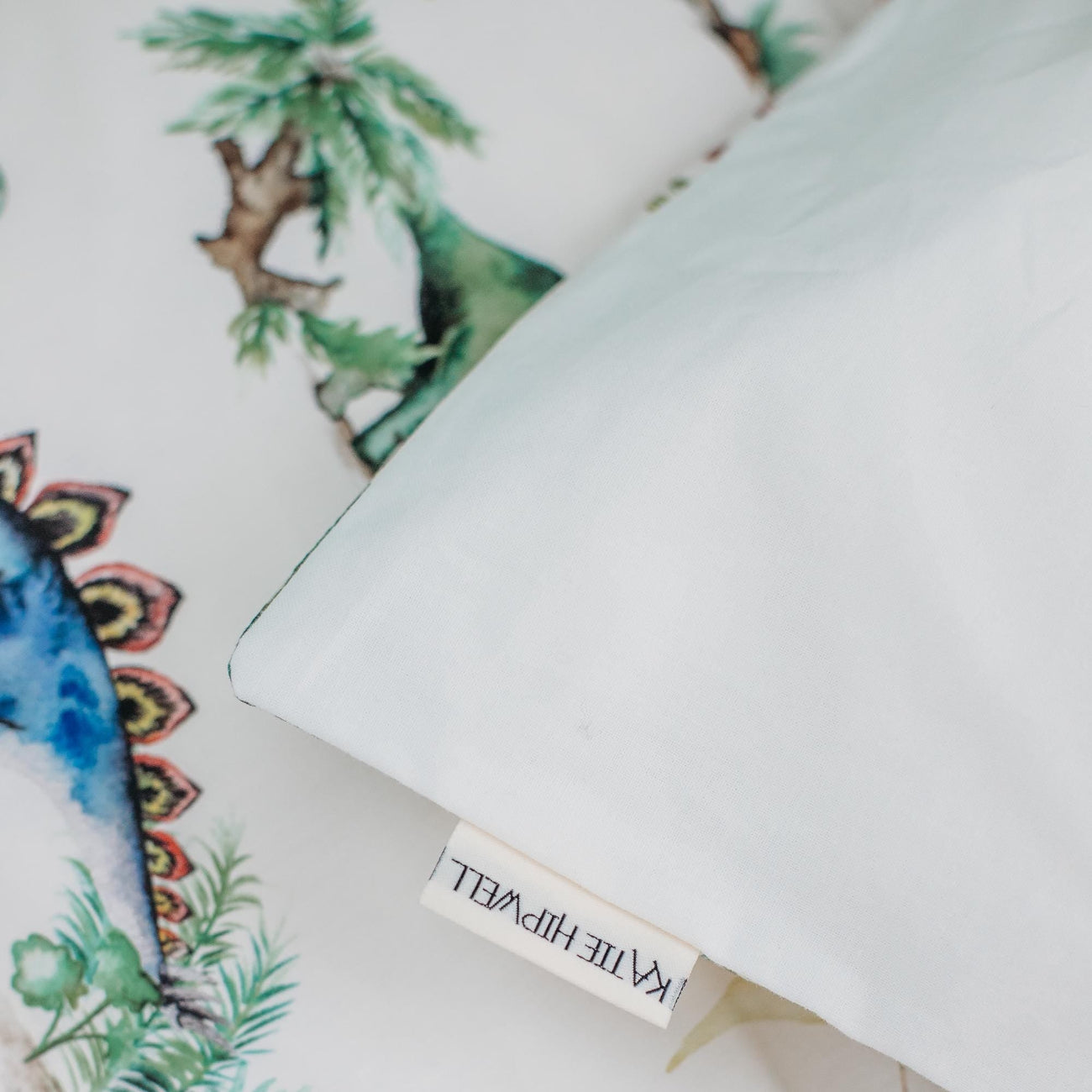 Product packaging with decorative design and brand name on a white background