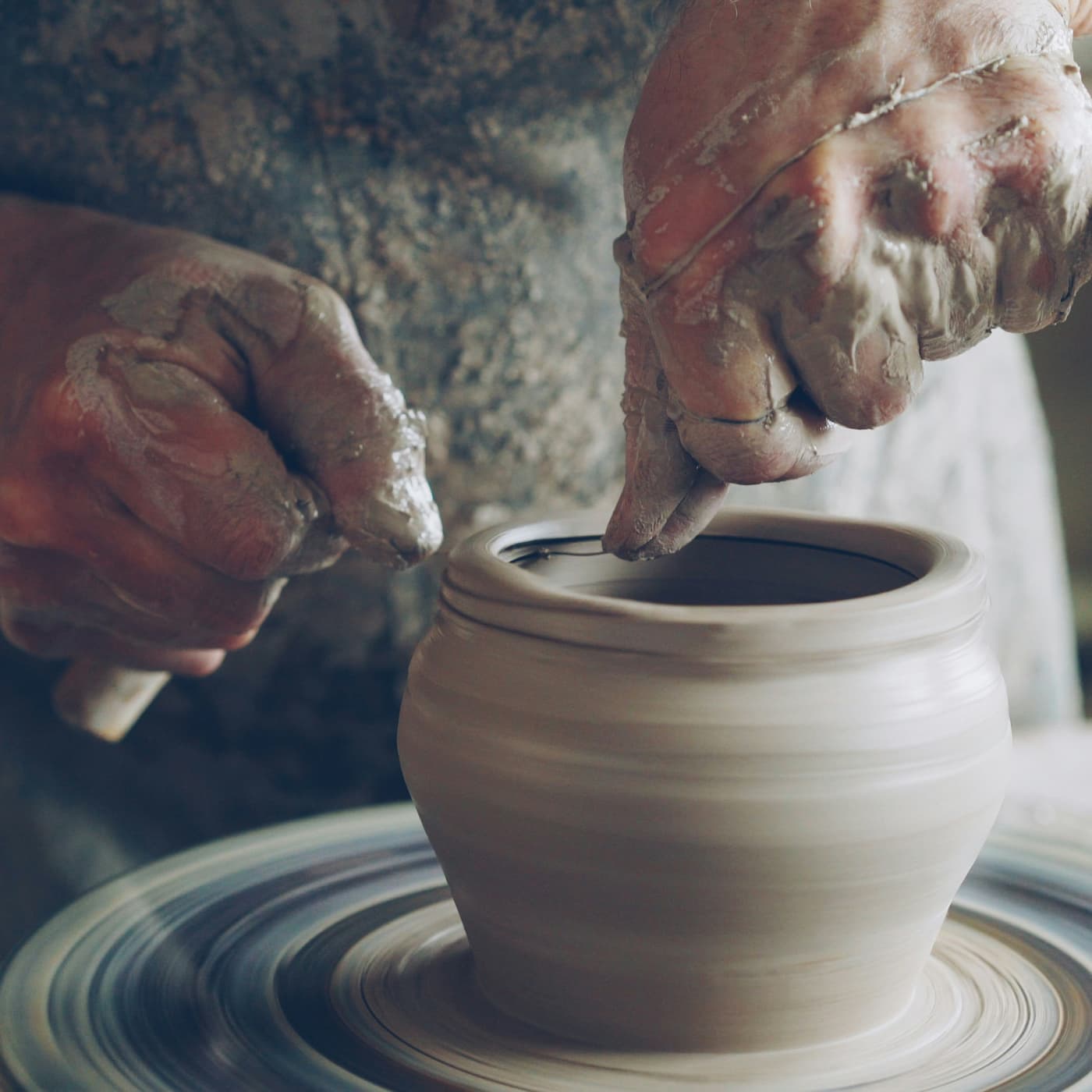 Shaping clay on a pottery wheel