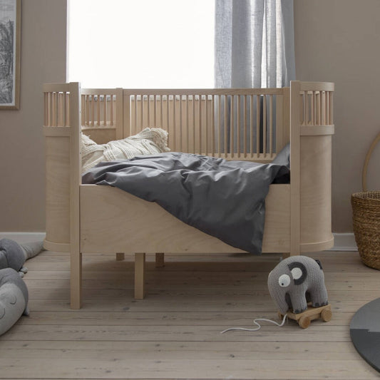 Wooden Edition Baby and Junior Bed showcasing its natural wood finish and clean lines