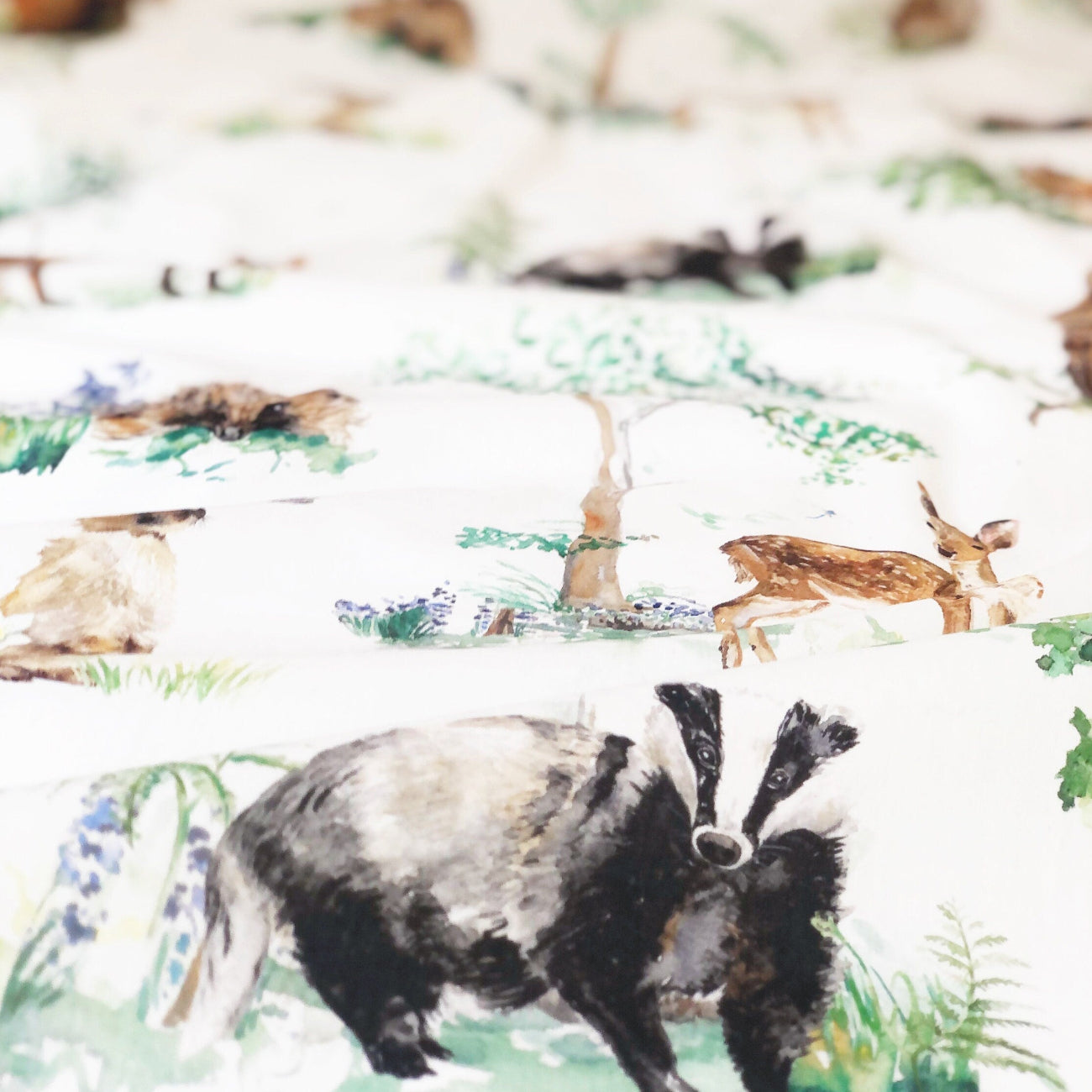 Fabric with badger and deer design in a natural setting