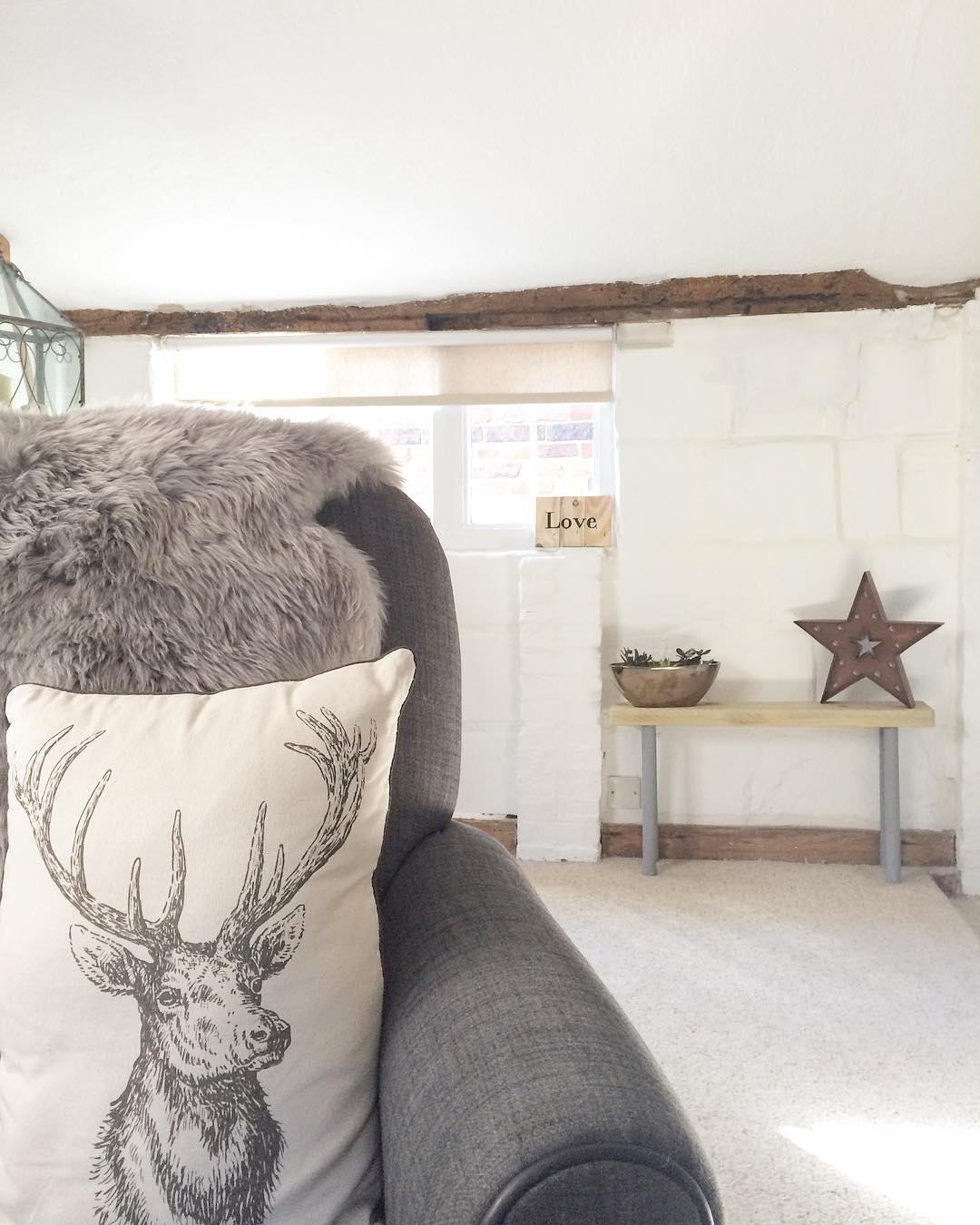 Living room armchair with a stag cushion: would you renovate a listed property? Amanda did. Find out how she got in here on www.lovetohome.co.uk - Photo credit: with permission from @theoldforgecottage