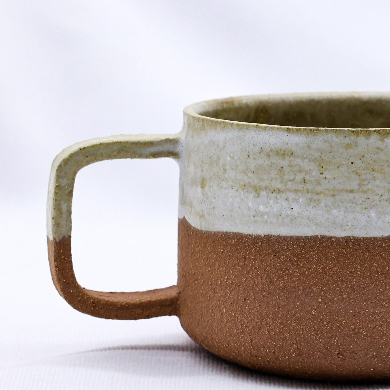 Ceramic mug with two-tone design on a white background