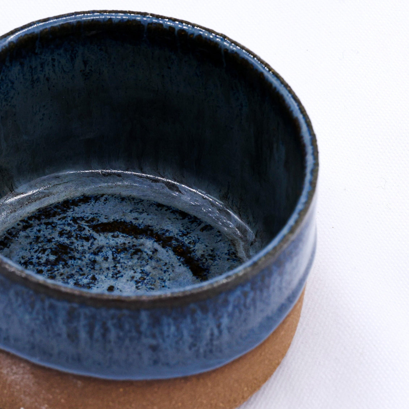 Close-up of a blue ceramic cup on a white background
