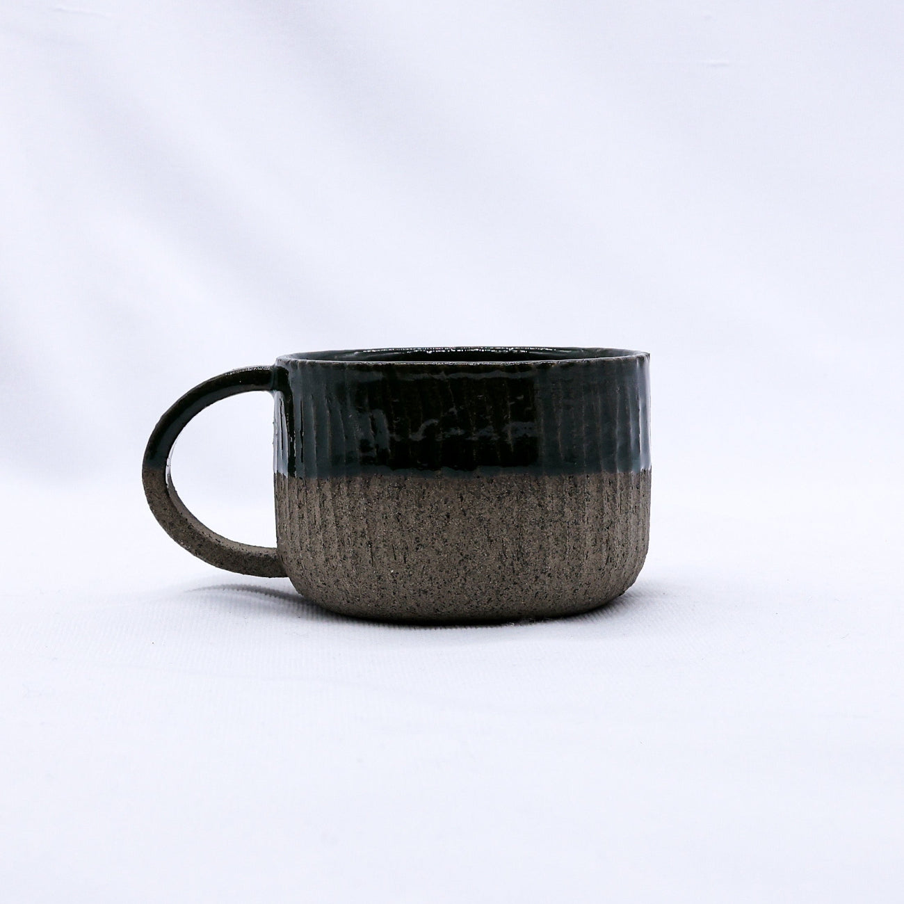 Smoked grey and brown ceramic mug on a white background