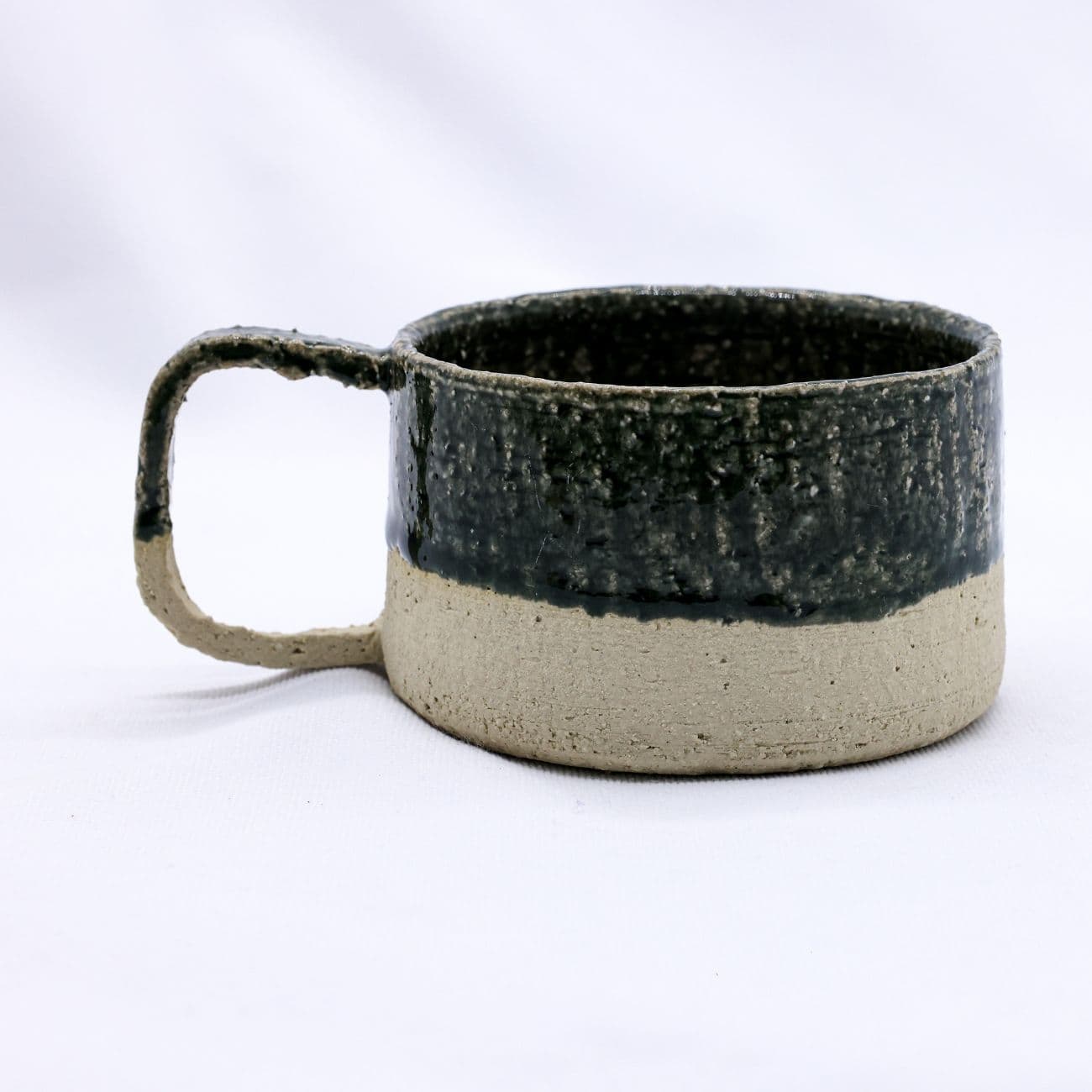 Ceramic mug with two-tone design on a white background