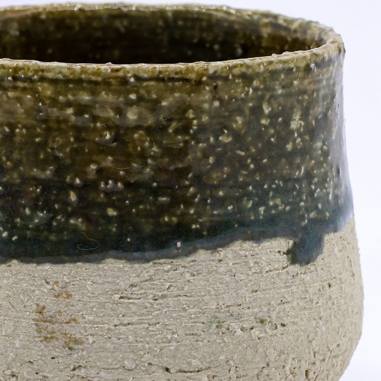 Ceramic bowl with two-tone glaze on a white background