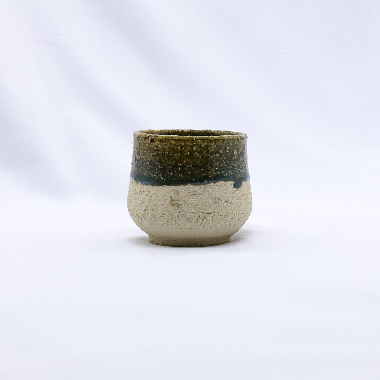 Ceramic cup with a black rim on a white background