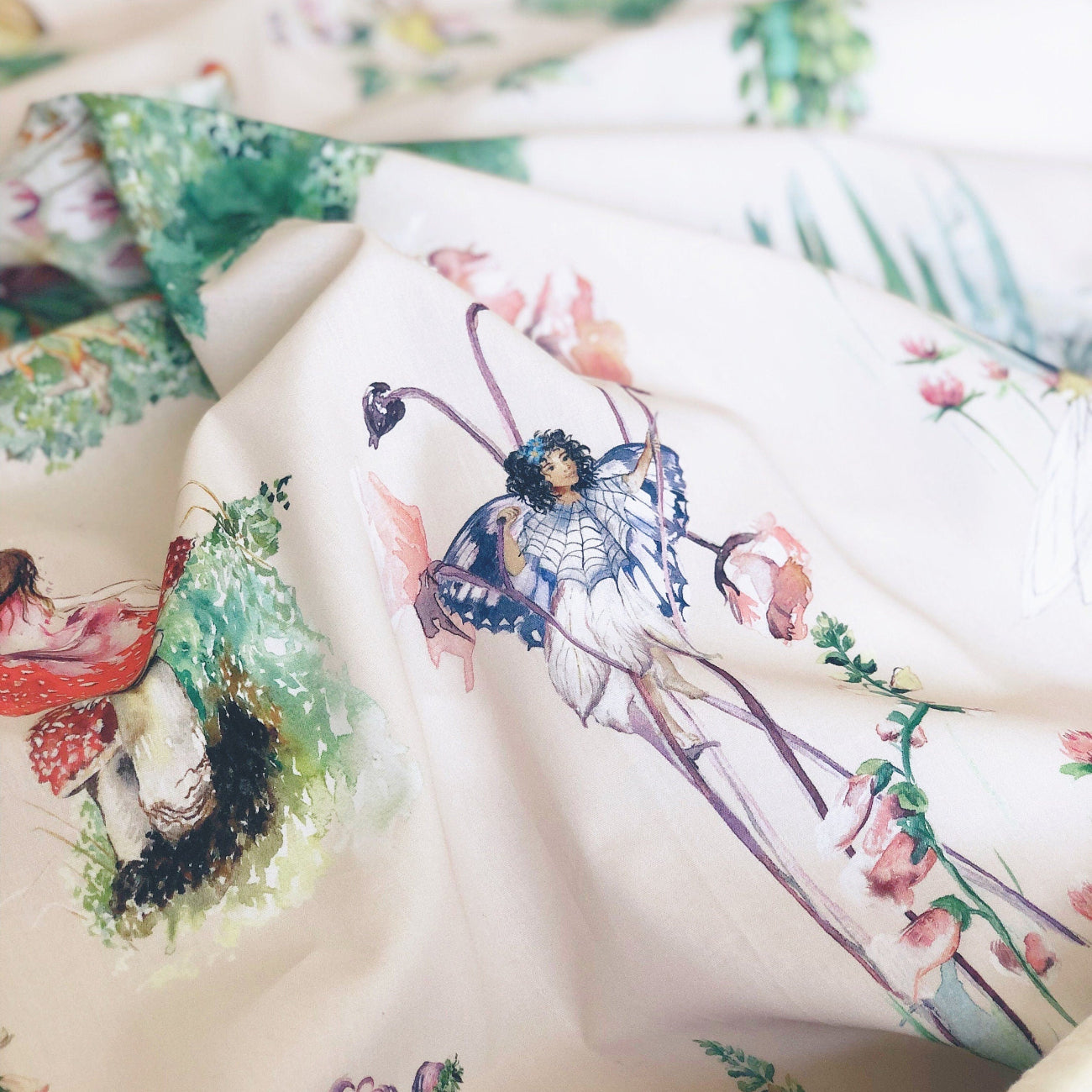 Fabric with artistic designs of people and nature on a white background