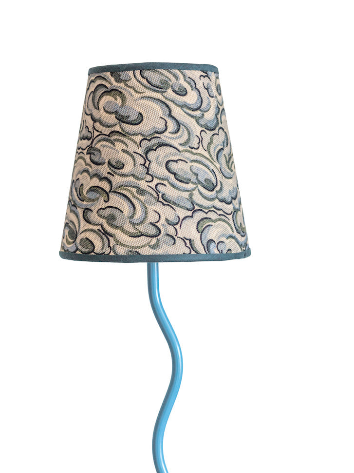 Lamp with decorative shade and blue base on a white background