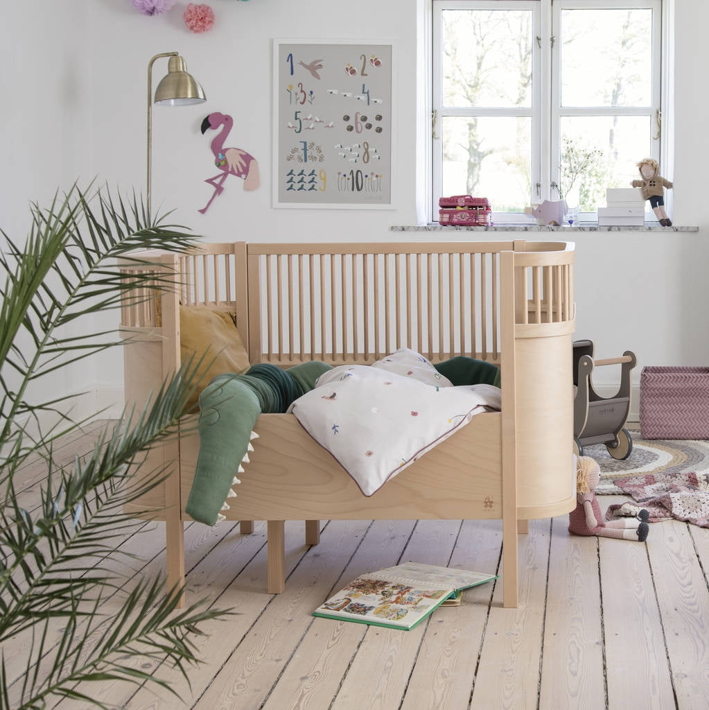 Sturdy wooden bed frame designed to grow with children, from baby to junior stages