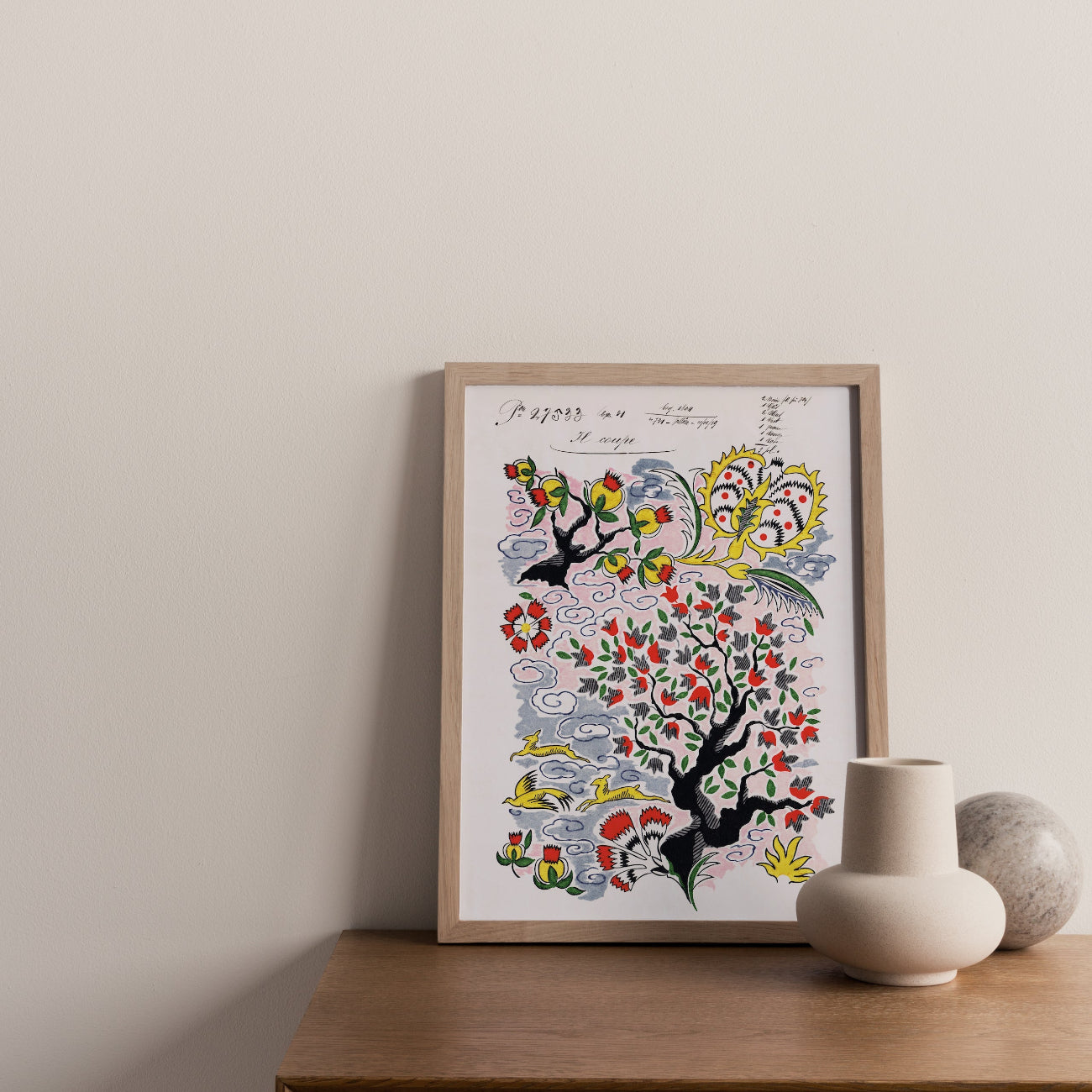 Framed tree of life print on a wooden surface with a neutral background