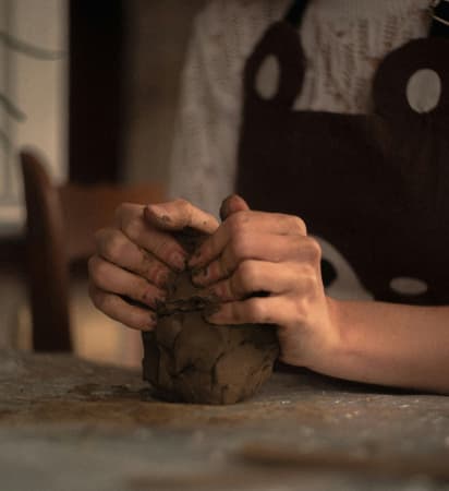 Person moulding clay with hands